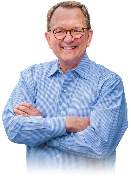 Smiling man in glasses and blue shirt.